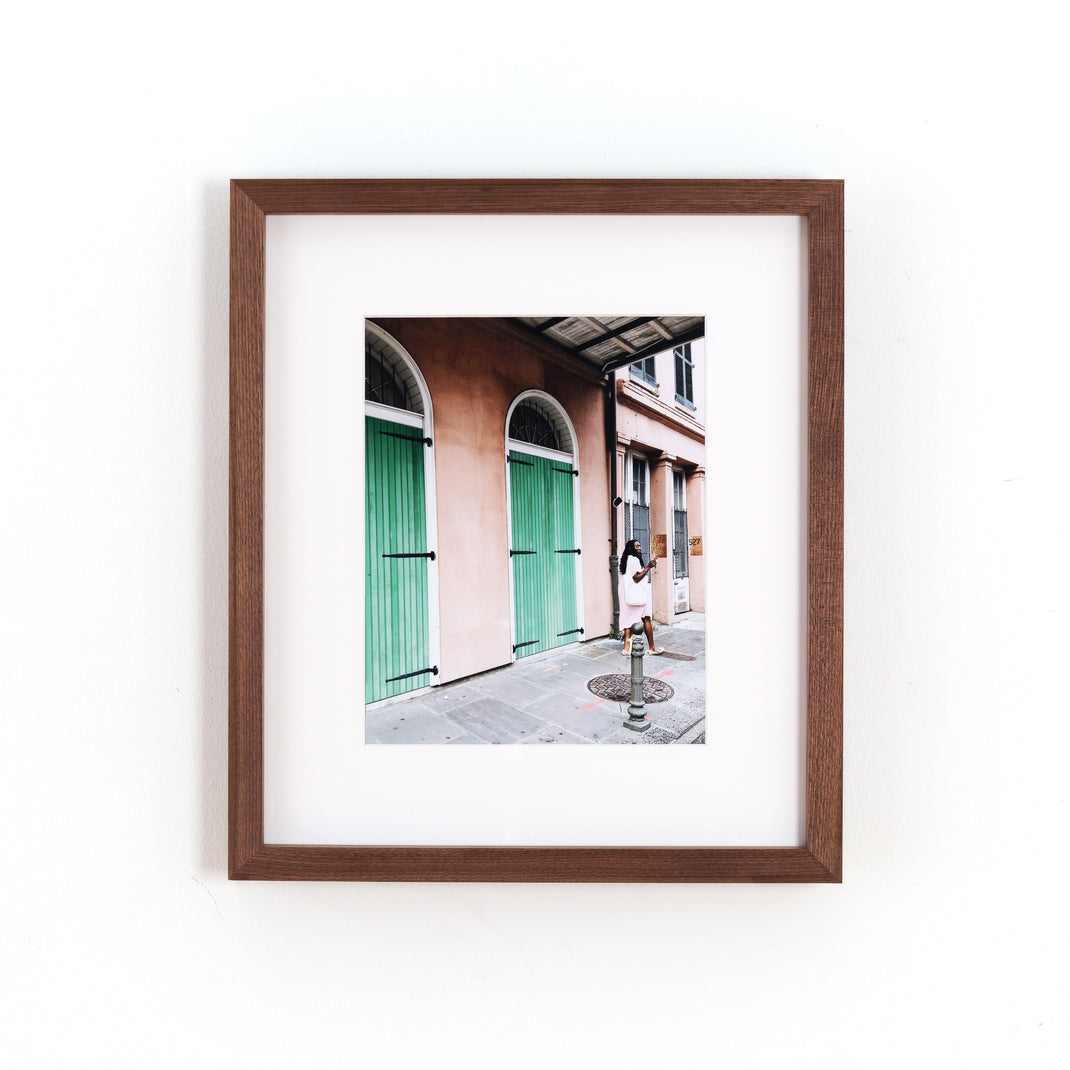 travel photo of a woman exploring framed in Walnut gallery hardwood frame style with a white mat
