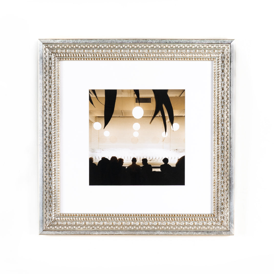interior photo of a bar framed in ornate silver Brighton frame with a white mat