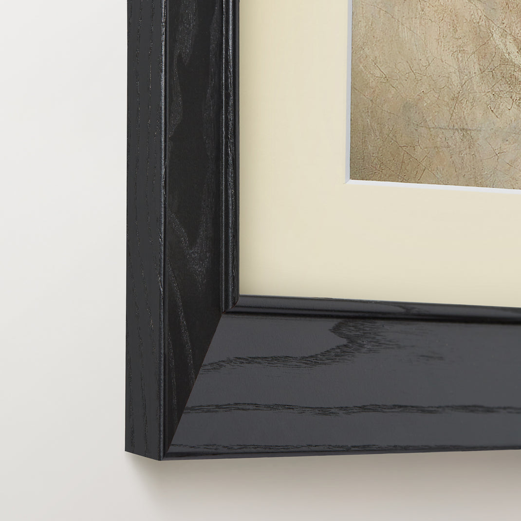 Bottom left corner of a dog portrait painting in a black ash angled frame