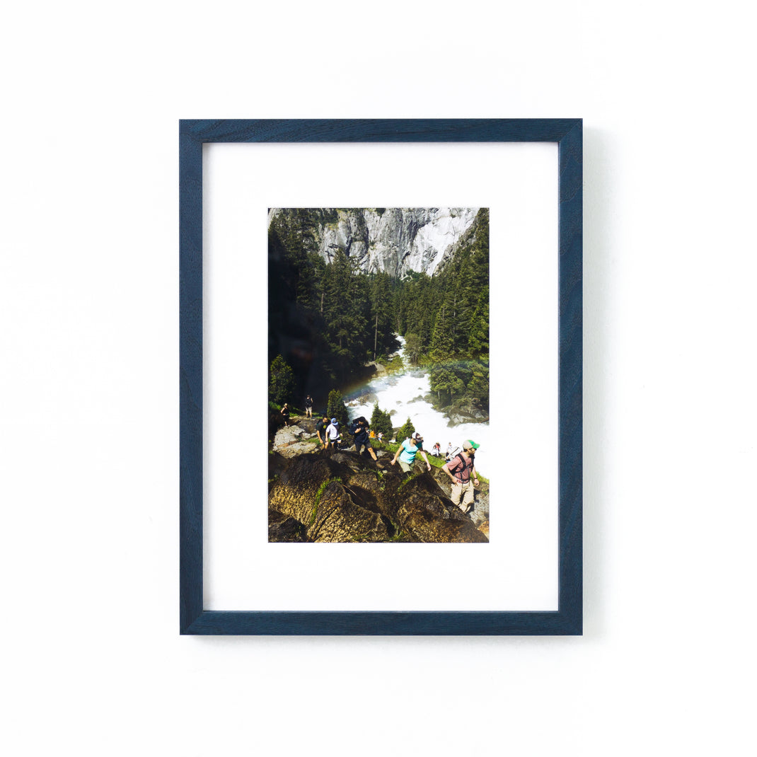photograph of hikers framed in Indigo Walnut frame with white mat