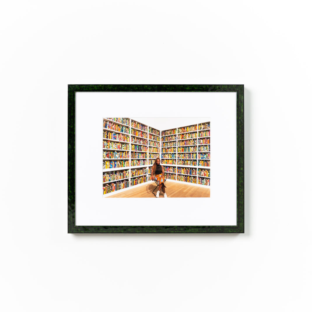 photograph of woman in front of books framed in London green glazed frame with a white mat