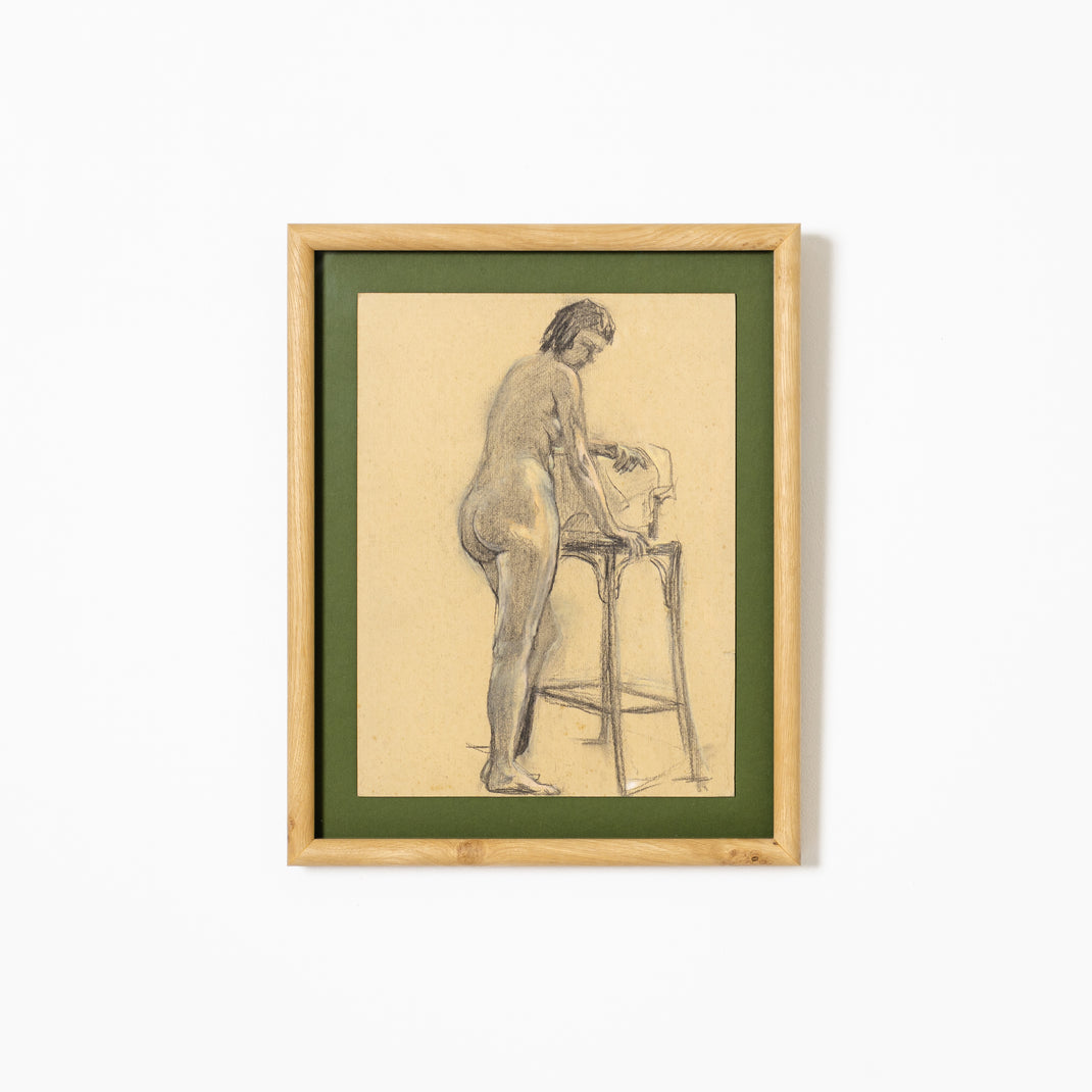 charcoal figure drawing framed in rounded burl wood frame with a green mat