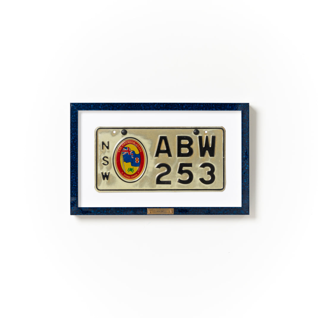 Australian license plate framed in deep blue glazed Sydney frame