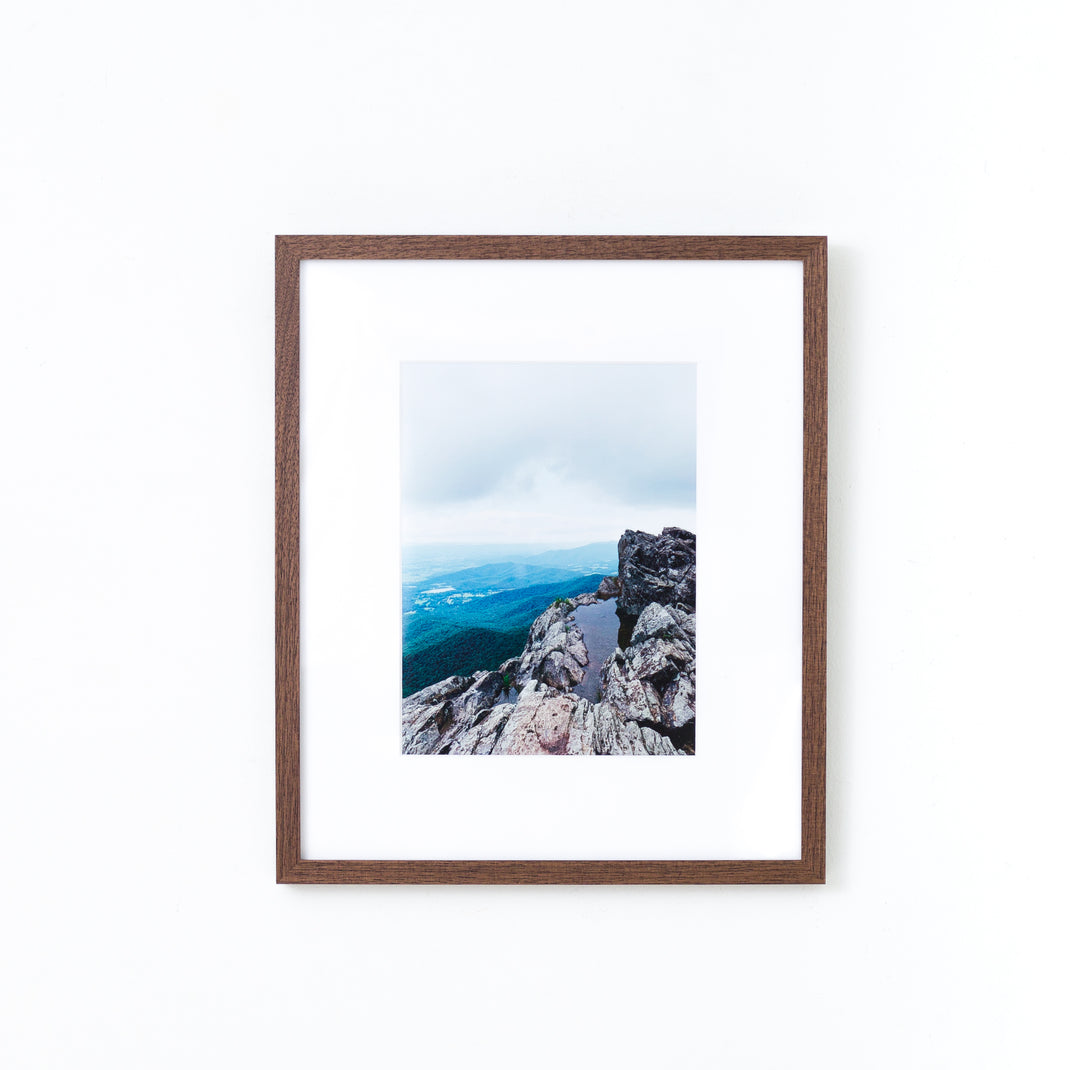 landscape photo of mountains framed in mini Walnut hardwood frame style with a white mat