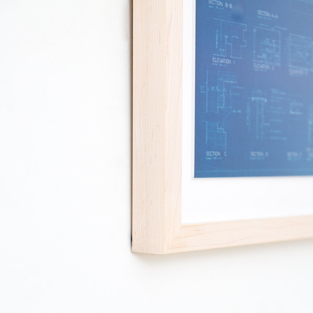 bottom left corner of architectural blueprint framed in bleached maple gallery frame