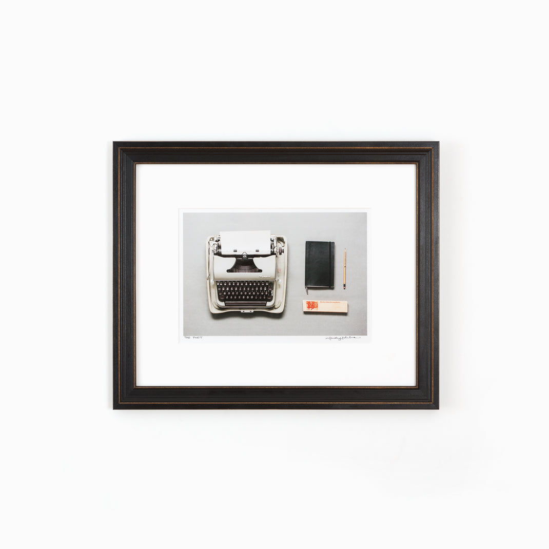 Photo of a typewriter framed in Augusta wide distressed black frame with white mat