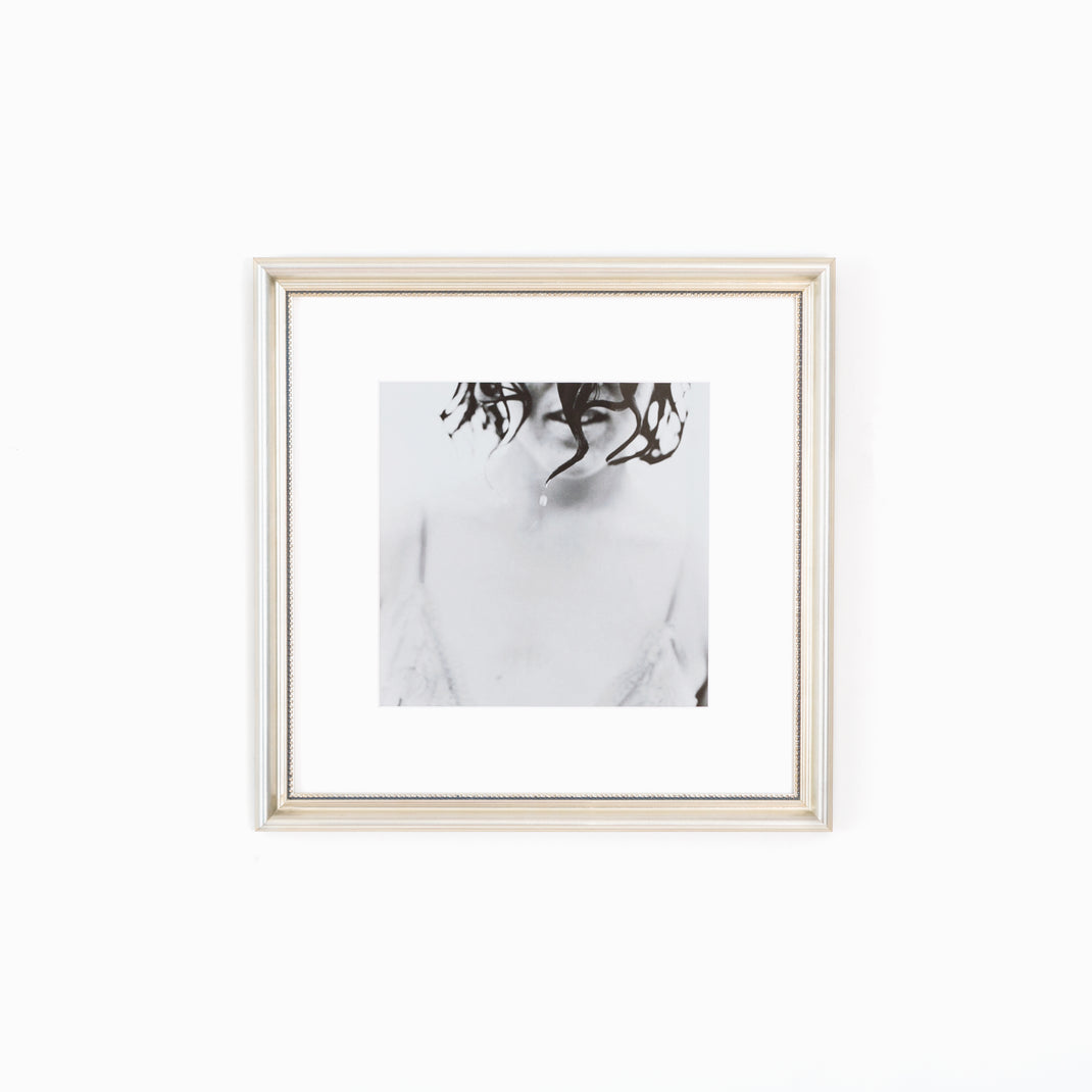 black and white photo of a woman framed in Buckhead silver beaded frame with white mat