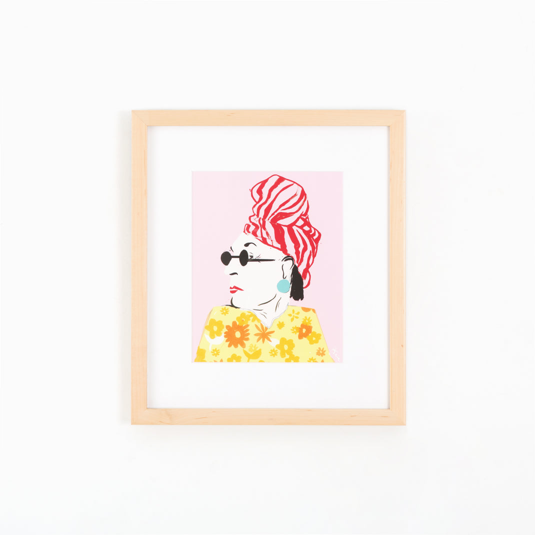 illustrated portrait of a woman in a floral dress framed in light wood Marin frame