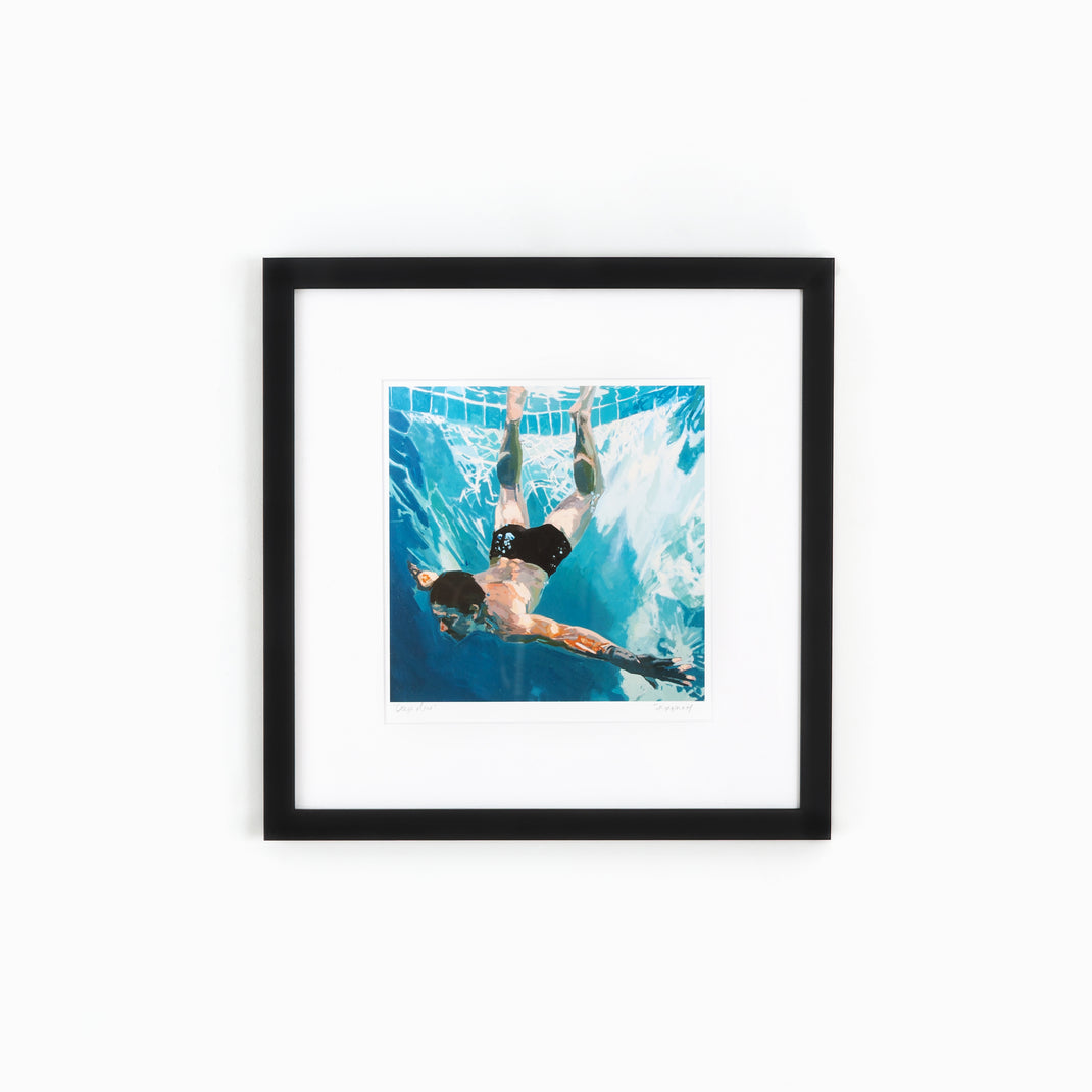 art print of a man swimming in a pool framed in thin black gallery Mercer Slim frame with a white mat